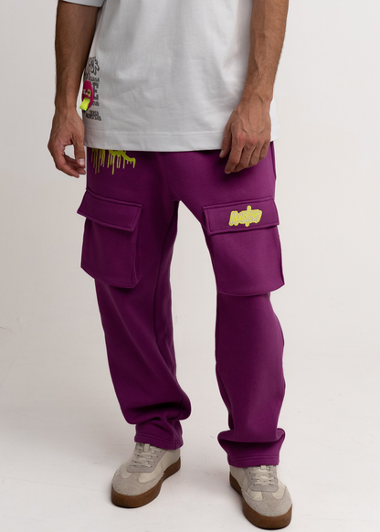Person wearing purple cargo pants with yellow accents on a white background
