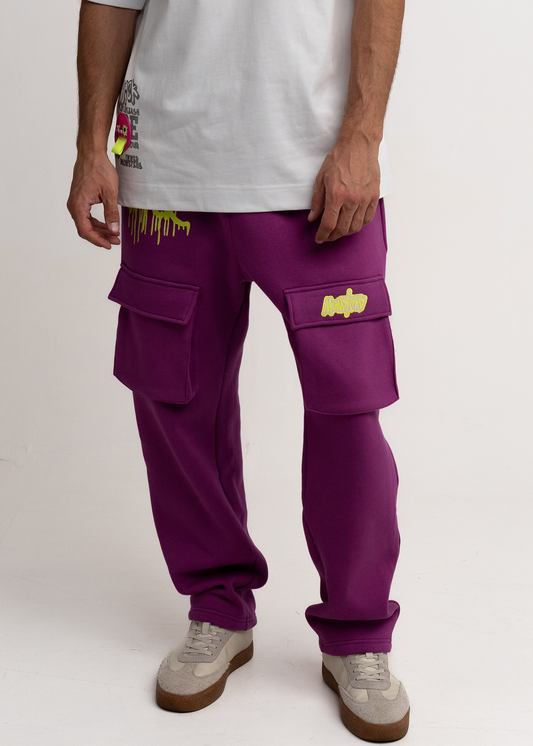 Person wearing purple cargo pants with yellow accents on a white background