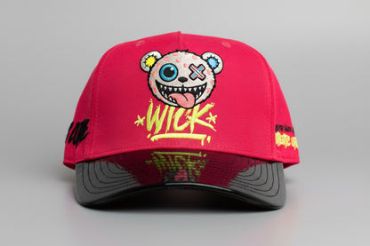 Red cap with a cartoon character and text on a metallic stool against a gray background